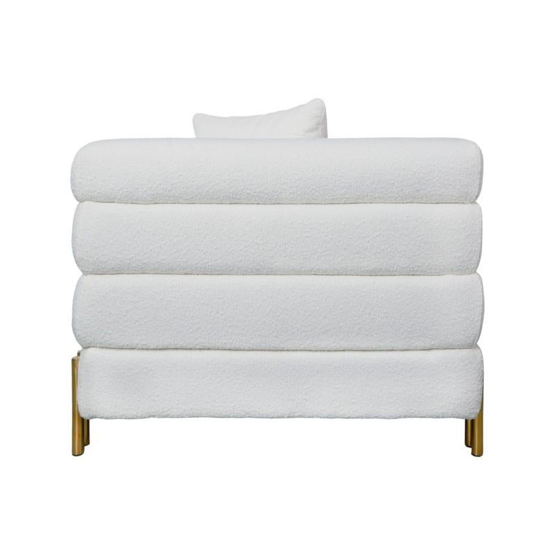 White plush sofa with gold legs, side view.