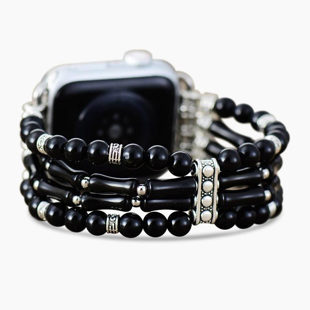 Smartwatch with black beaded bracelet.