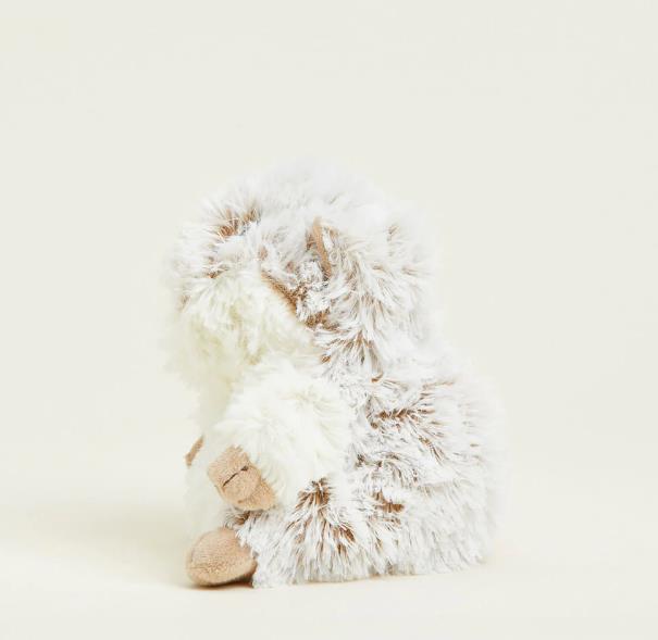 Fluffy plush toy hedgehog on a plain background.