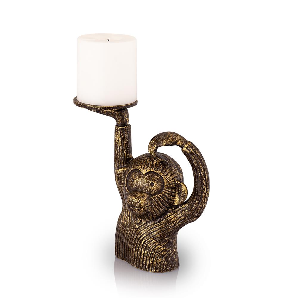 Monkey-shaped candle holder with a white candle on top.
