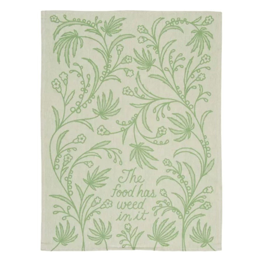 Decorative towel with green botanical pattern and humorous text.