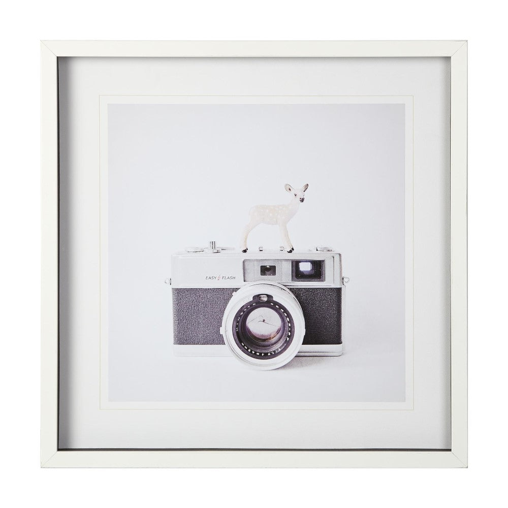 Vintage camera with a tiny deer figure on top, framed.