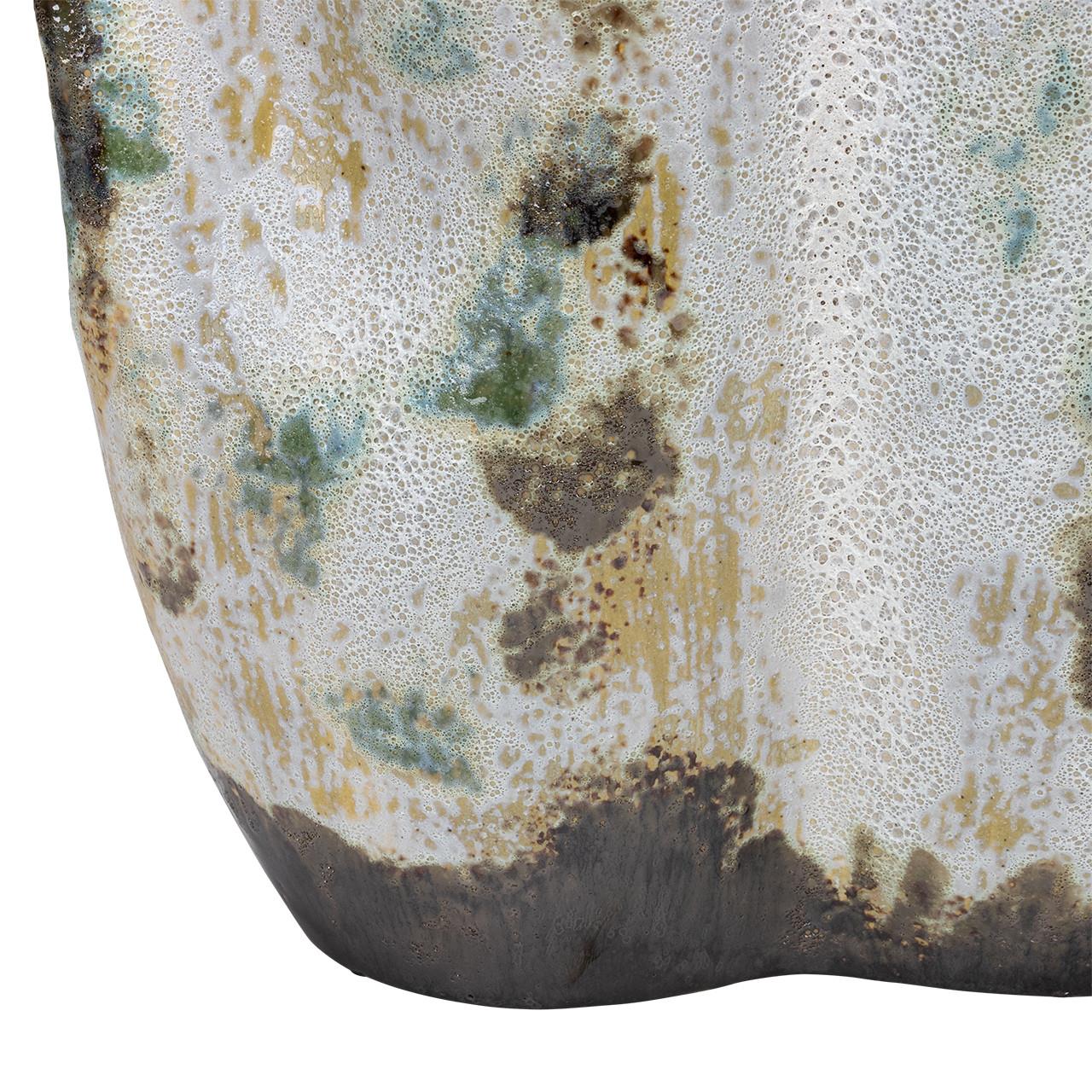 Close-up of textured ceramic with mottled, earthy glaze.