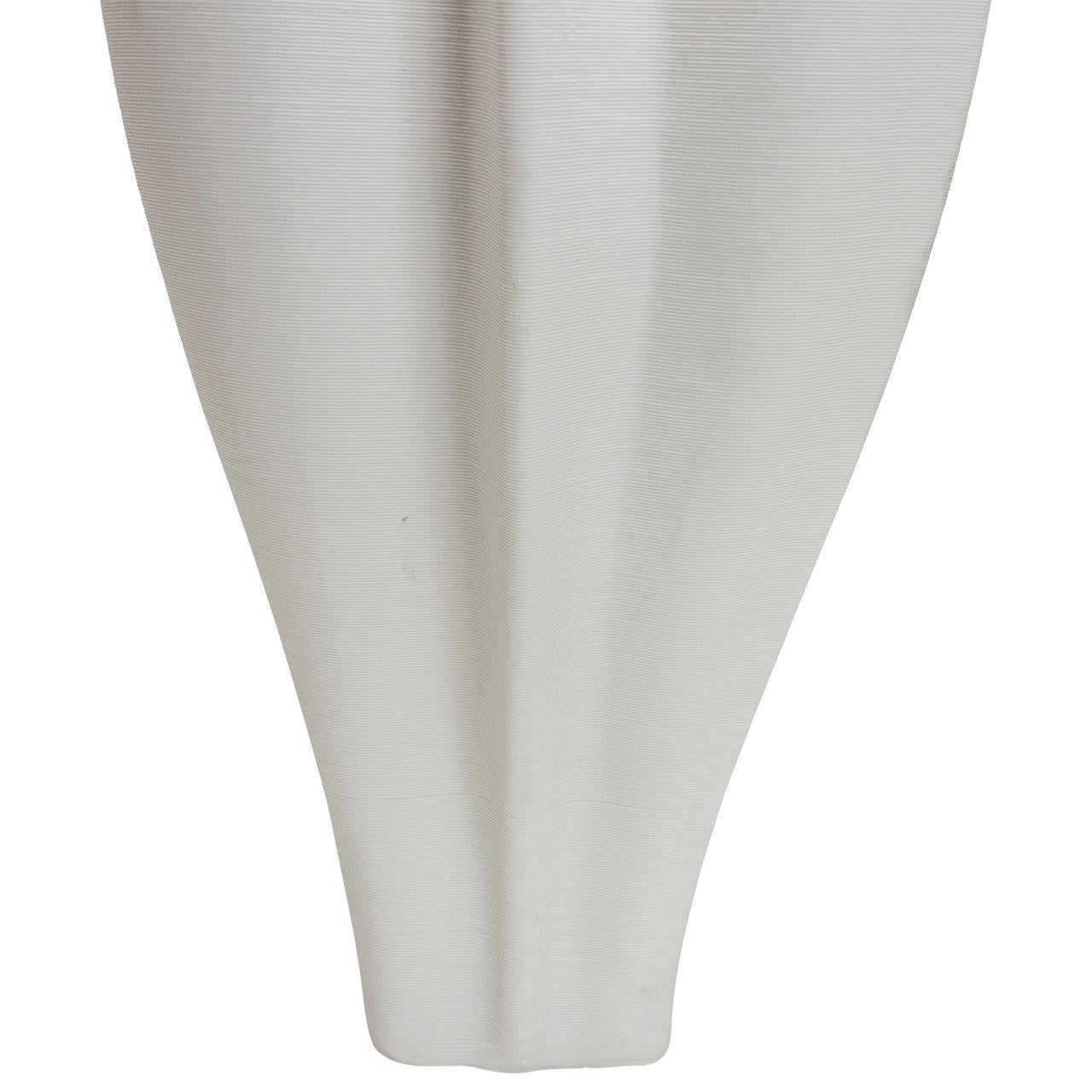 Close-up of a textured white vase with a vertical seam.