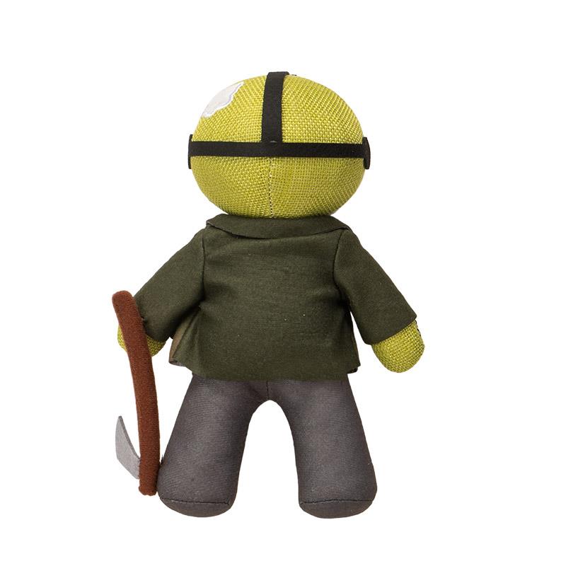 A plush doll with green jacket and holding a stick, facing away.