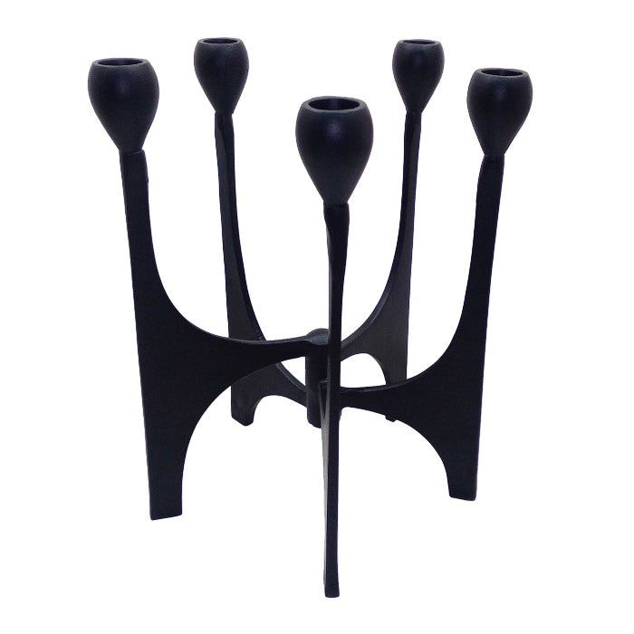 A black, sculptural candle holder with five arms.