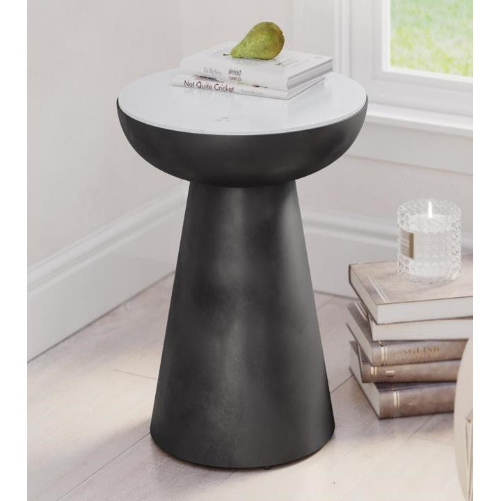 Modern side table with a pear and books on top.