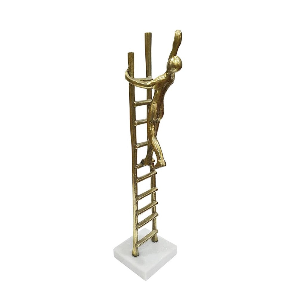 Golden figurine climbing ladder on marble base.
