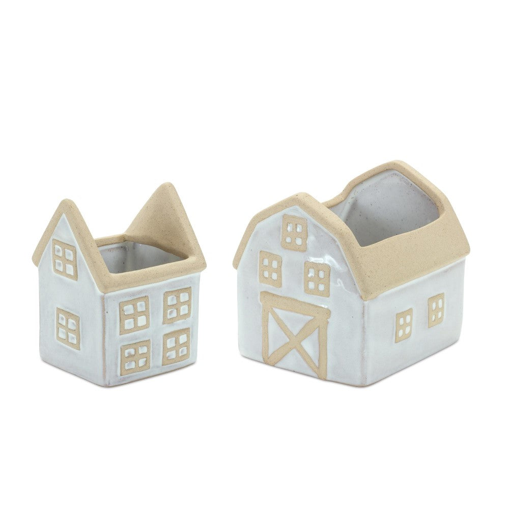 Two small ceramic houses, one barn-shaped and beige.