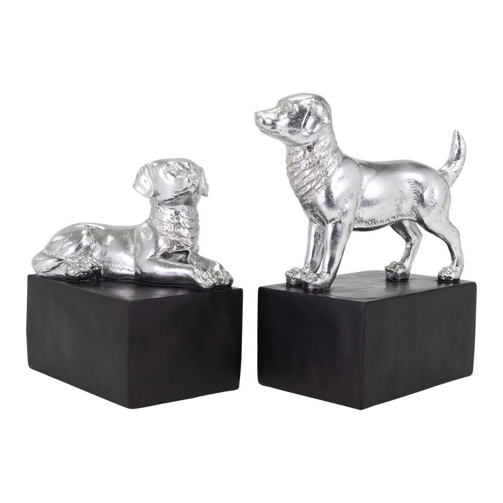 Two silver dog sculptures on black rectangular bases.