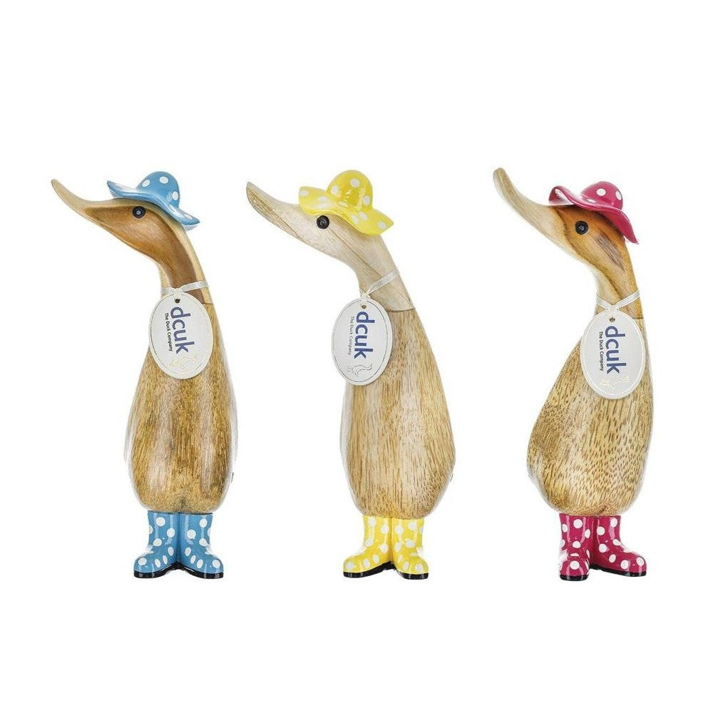 Three wooden ducks with hats and polka-dot boots in blue, yellow, and red.