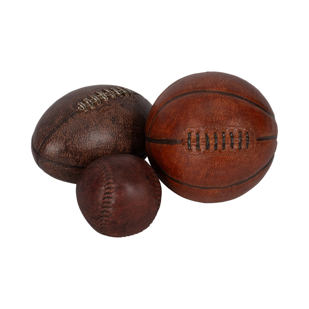 Vintage style football, basketball, and baseball on display.