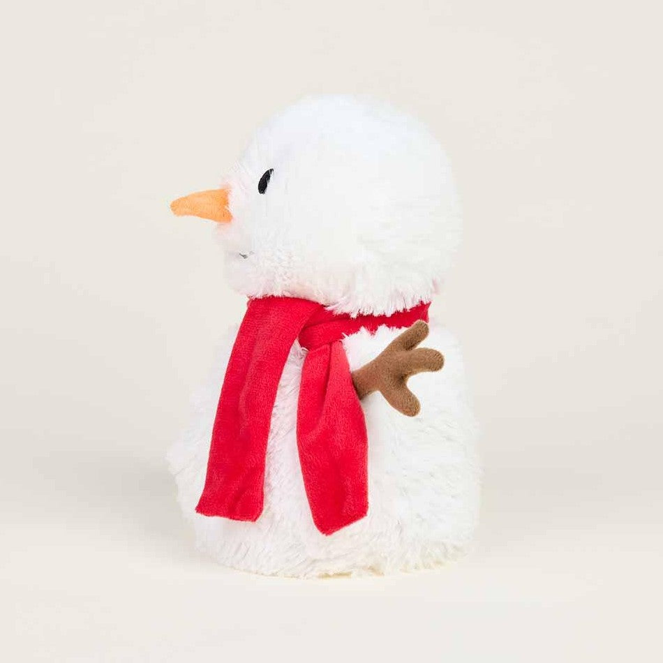 Plush snowman with red scarf and carrot nose, side view.