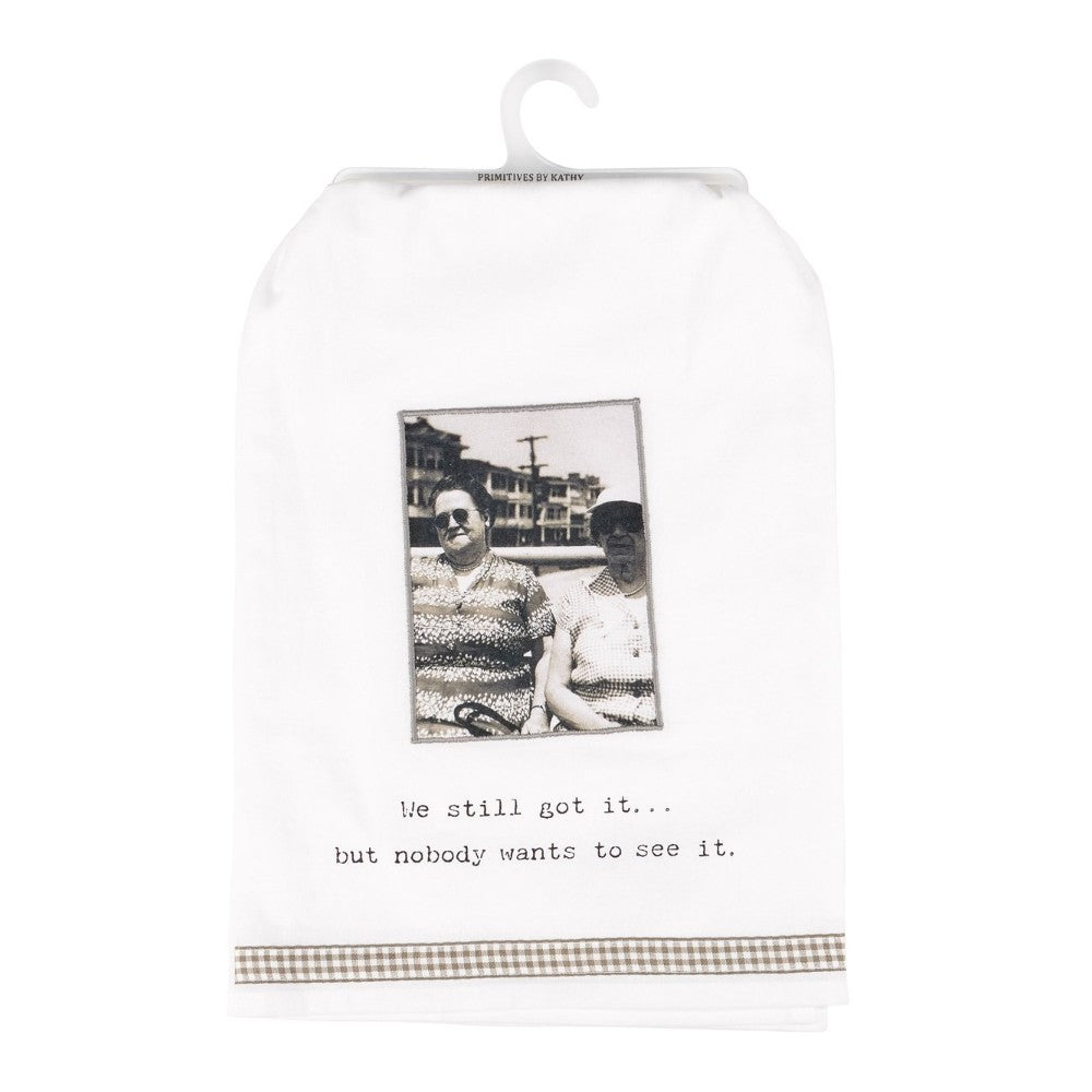 Retro photo tea towel with humorous text, "We still got it... but nobody wants to see it."