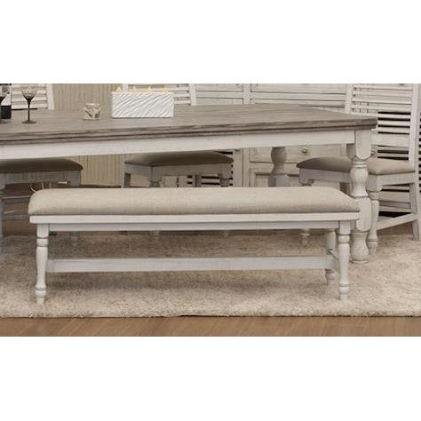 Rustic dining table with beige bench on a light carpet.