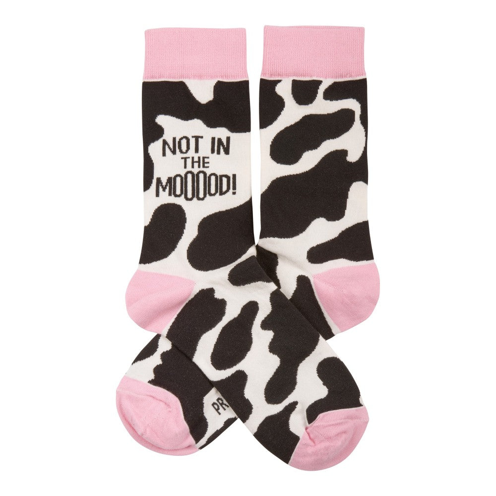 Cow-print socks with "NOT IN THE MOOOOD!" text and pink accents.