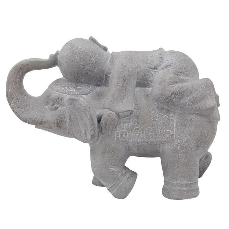 Stone elephant with a figure on its back, ornate carvings.