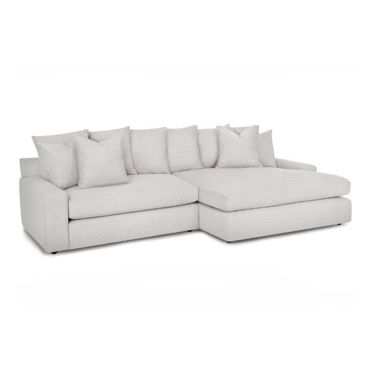 Light gray sectional sofa with plush cushions.