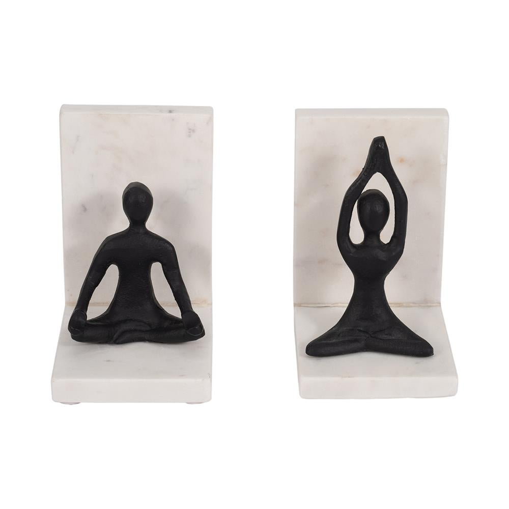 Two abstract yoga figurines on white marble bookends.