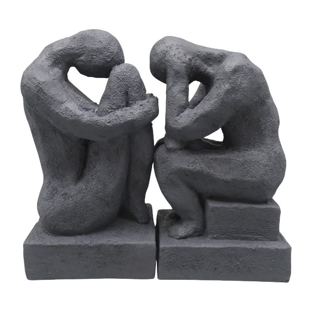 Two abstract, textured figures in seated, contemplative poses.