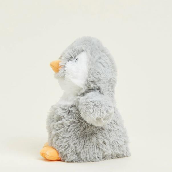 Fluffy grey penguin plush on a light background.