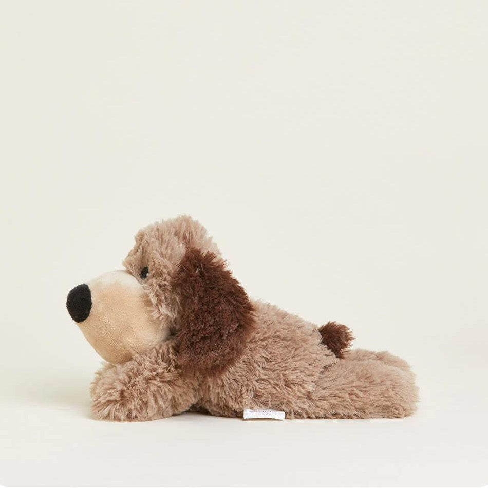 Fluffy brown plush dog toy lying on its belly.