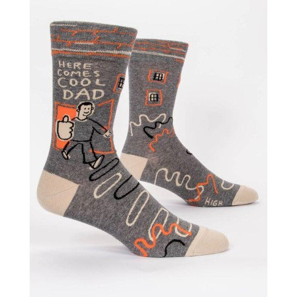 Gray socks with "Here Comes Cool Dad" and colorful abstract designs.