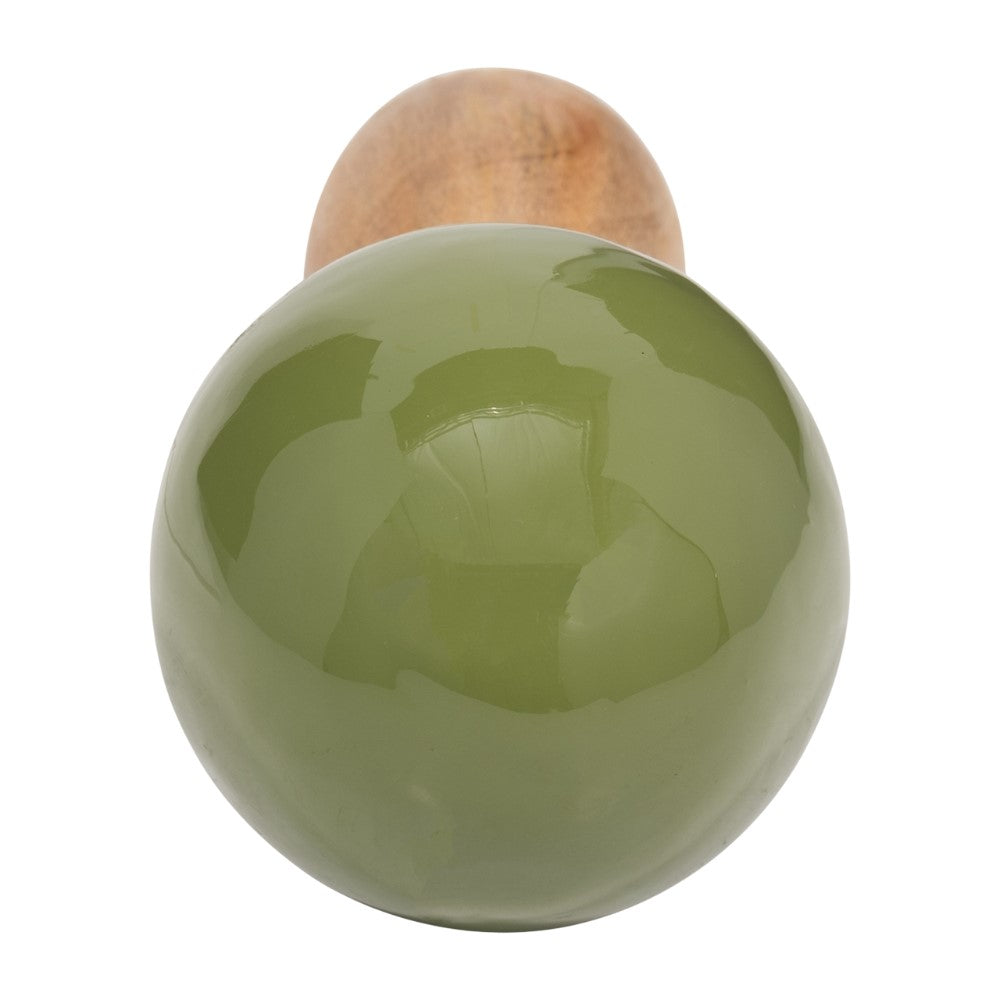 Green glossy sphere and wooden sphere in the background.
