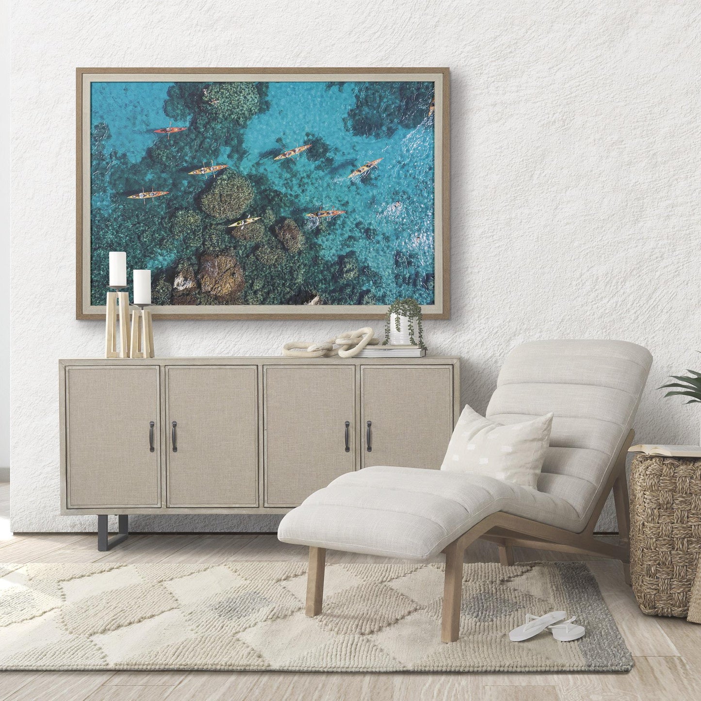 Cozy room with lounge chair, cabinet, and coastal wall art.