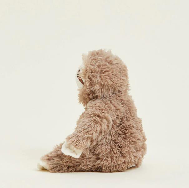 Fluffy stuffed sloth toy sitting sideways.
