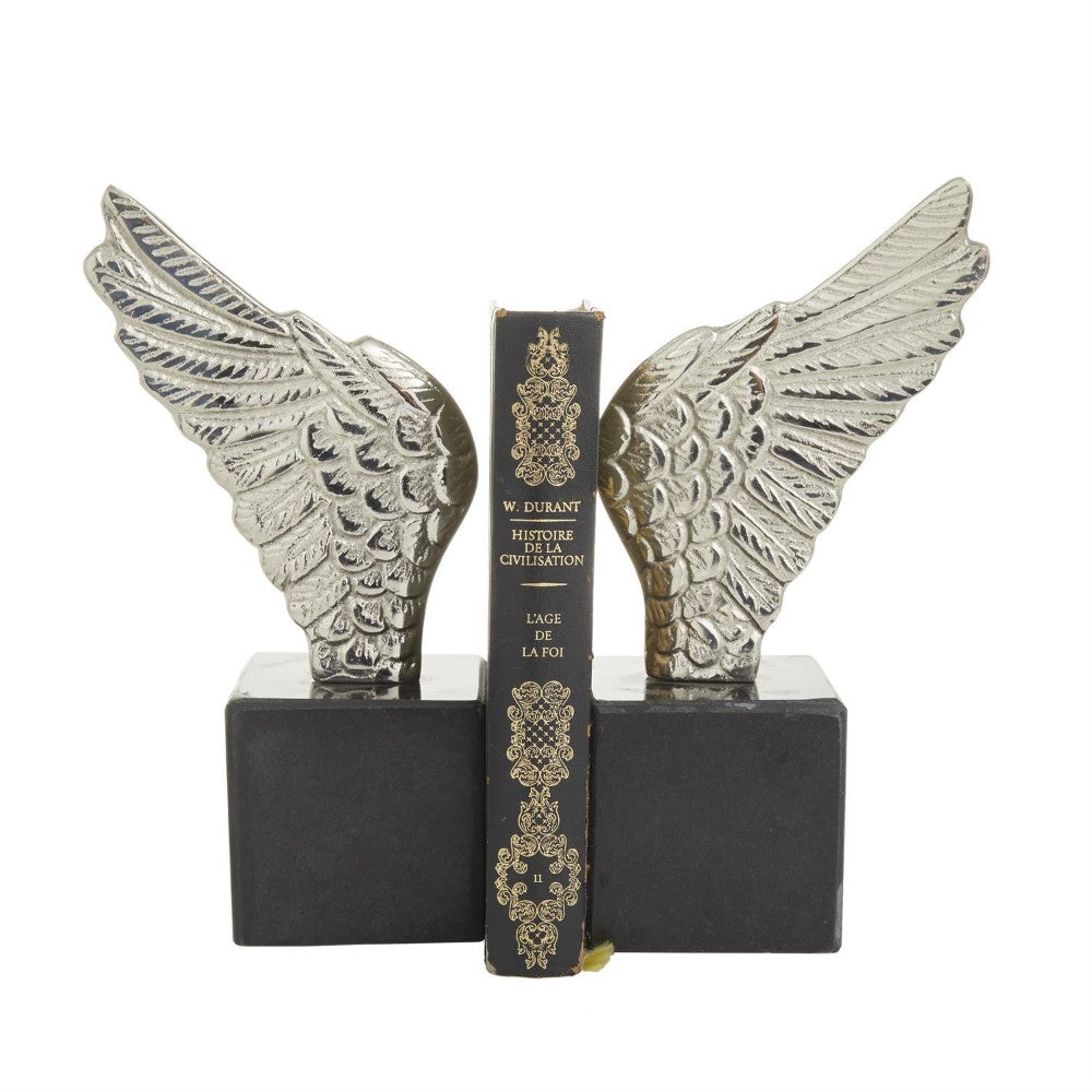 Silver wing bookends holding a black book upright.