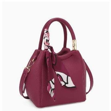 Maroon handbag with scarf accent and gold detailing.