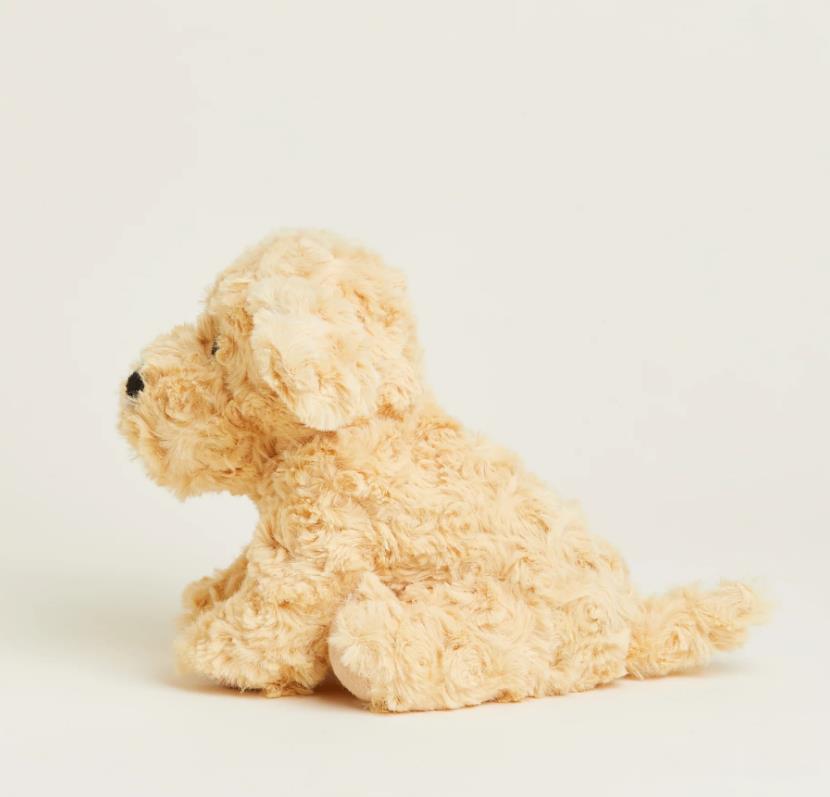 Fluffy beige stuffed animal dog sitting on a white background.