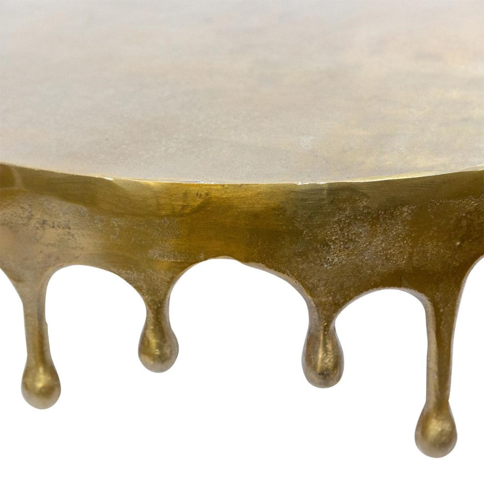Metal tabletop with a dripping gold edge design.