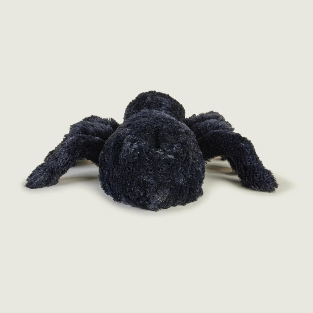 Dark plush spider toy on a light background.