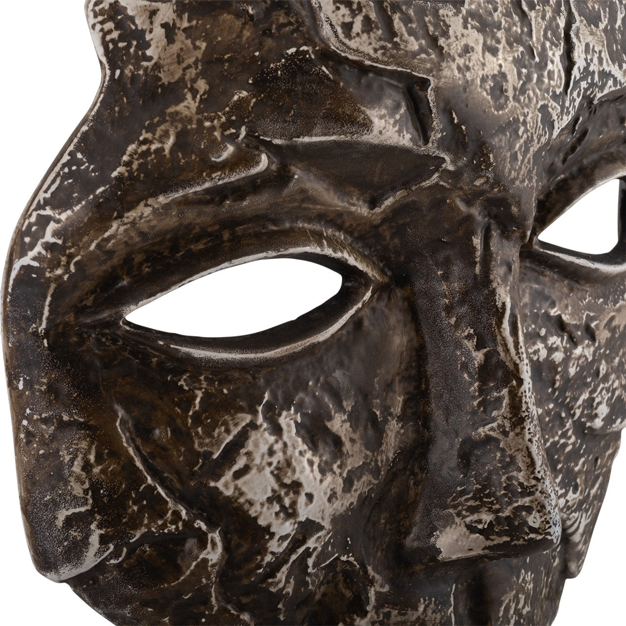 Rough, textured stone or metal mask with eye holes.