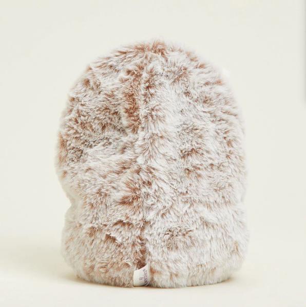 Fluffy, beige faux fur hat on a light background.
