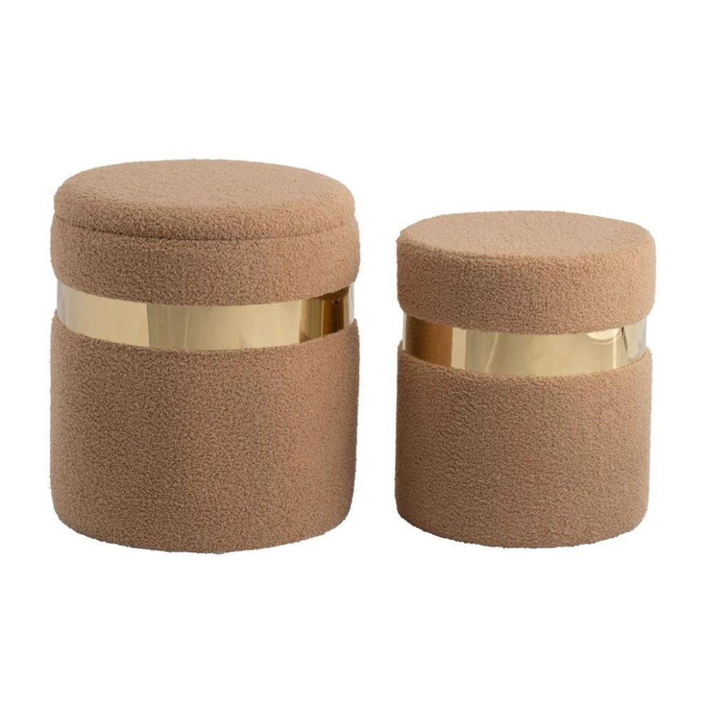 Two beige cylindrical stools with gold accents.