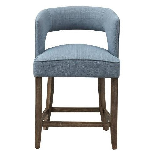 Blue upholstered bar stool with wooden legs and open back design.