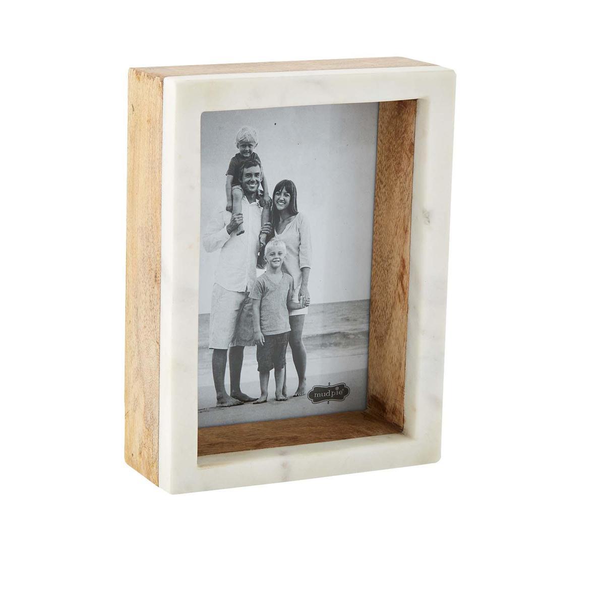 Wooden photo frame with a family beach photo inside.