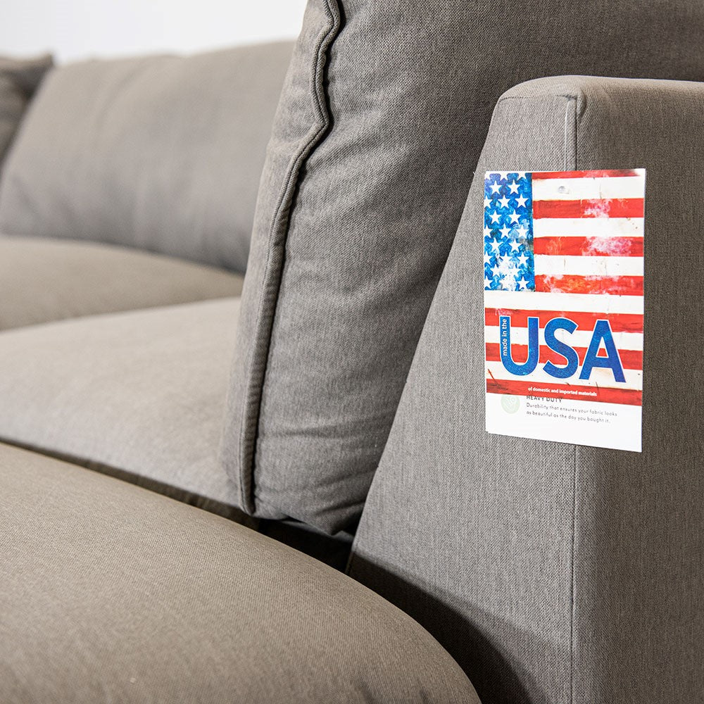 Gray couch with a "Made in USA" tag attached.