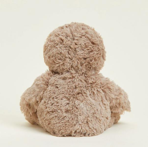 Fluffy teddy bear facing away, soft texture.