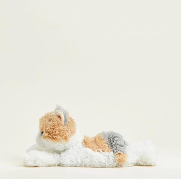 Plush cat toy laying on its belly against a pale background.