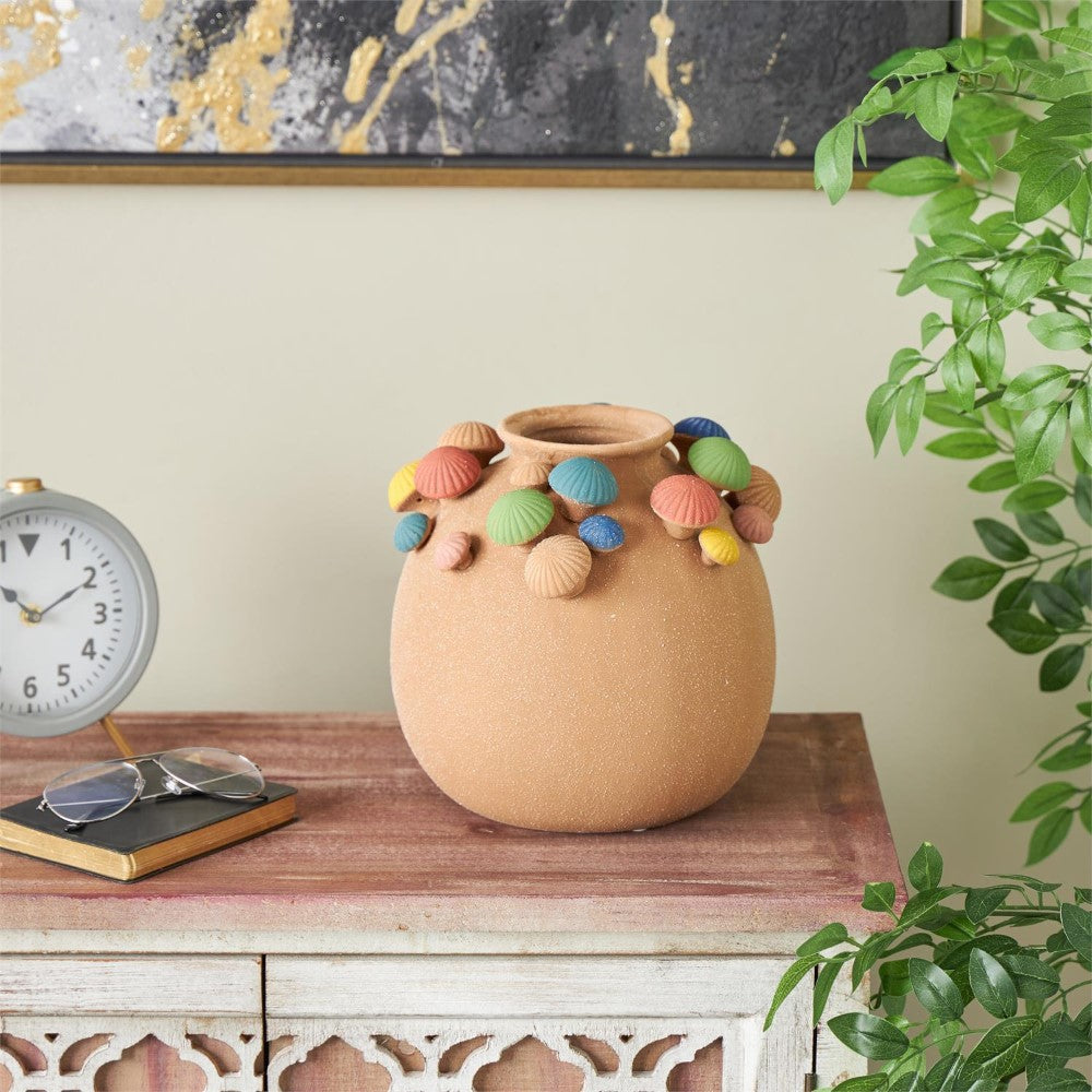 Colorful seashell vase, clock, glasses on a rustic table.