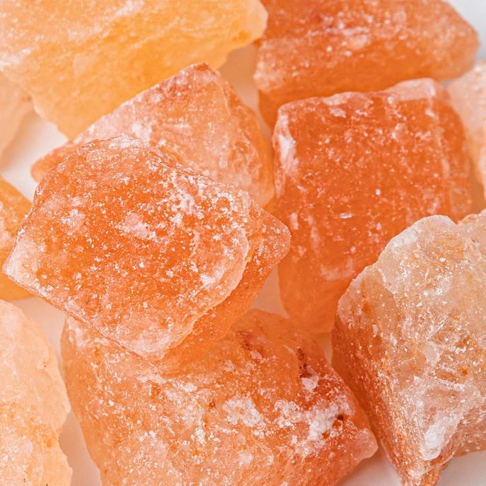 Close-up of orange and white rock sugar crystals.