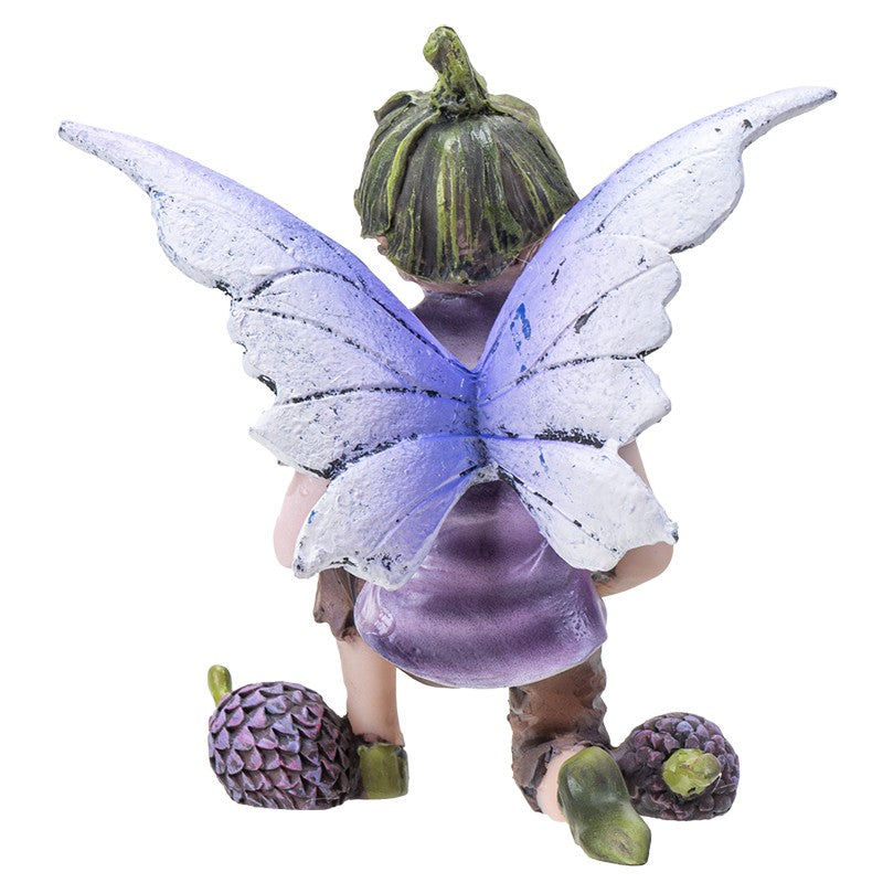 Fairy figurine with purple wings and acorn cap, kneeling with pine cones.