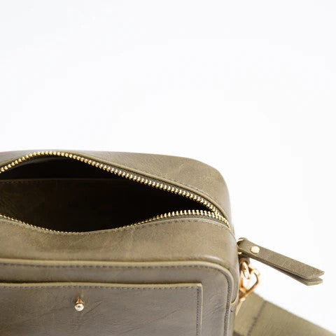 Olive green leather shoulder bag with zipper partially open.