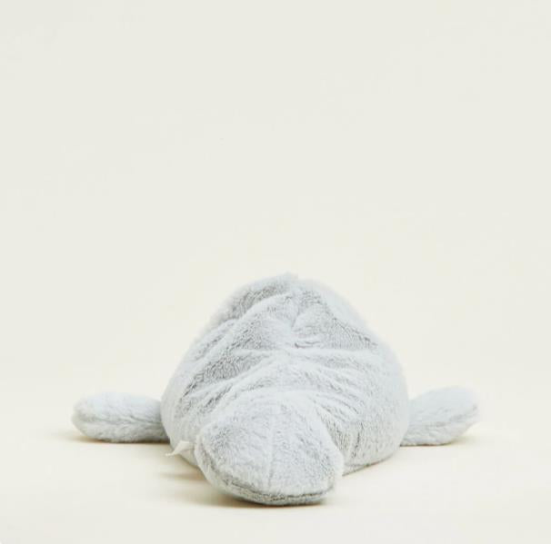 Plush toy dolphin lying flat on a plain background.