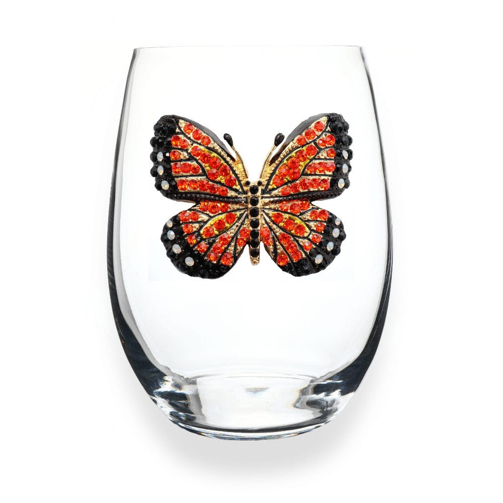 Clear glass with an ornate orange butterfly design.