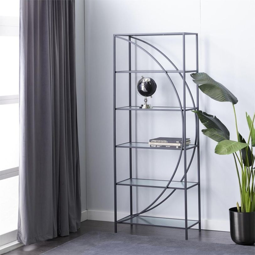 Modern shelf with globe and books, flanked by plant and gray curtain in bright room.